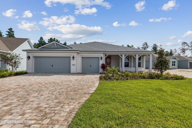 613 Witty Banter Ct, Yulee, FL 32097 - ranch-style home with decorative driveway, a garage, a front yard, a porch, and roof with shingles
