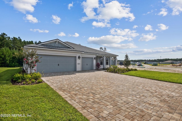 613 Witty Banter Ct, Yulee, FL 32097 - single story home featuring decorative driveway, a front lawn, a garage, and roof with shingles