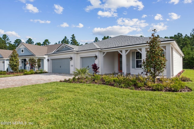 613 Witty Banter Ct, Yulee, FL 32097 - single story home with an attached garage, decorative driveway, a front lawn, and roof with shingles