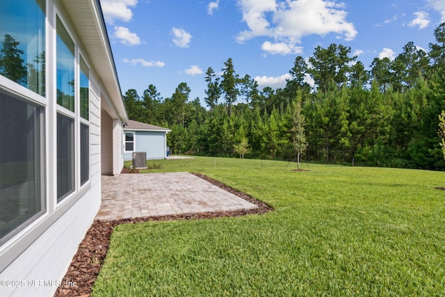 613 Witty Banter Ct, Yulee, FL 32097 - view of green lawn with a patio area and a view of trees