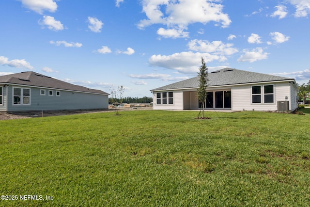 613 Witty Banter Ct, Yulee, FL 32097 - rear view of house with a lawn and roof with shingles