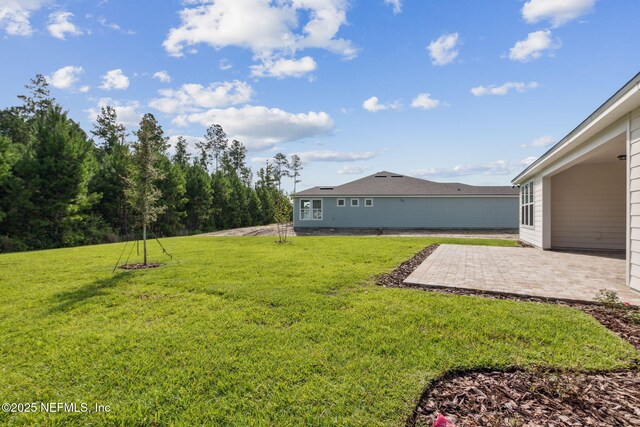 613 Witty Banter Ct, Yulee, FL 32097 - view of grassy yard featuring a patio area