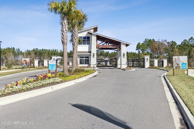 613 Witty Banter Ct, Yulee, FL 32097 - view of asphalt street featuring a gate, curbs, and a gated entry