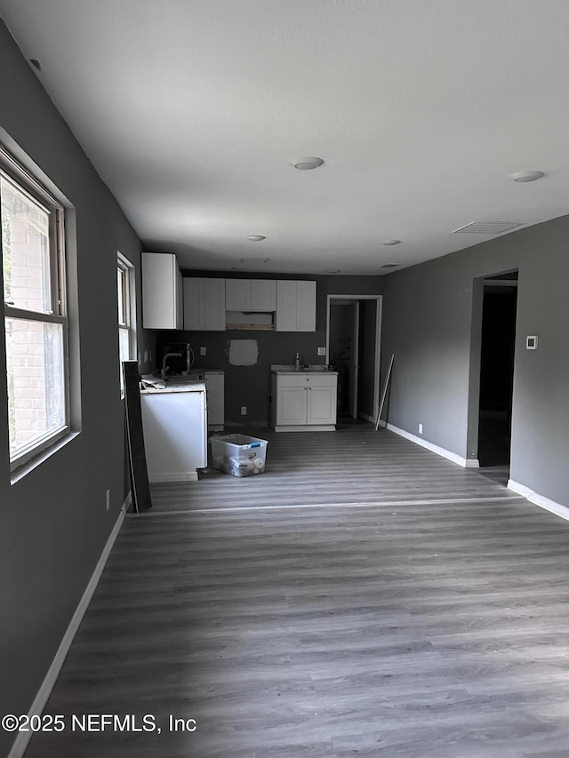 9846 Highland Ave, Jacksonville, FL 32208 - kitchen with white cabinets and wood finished floors