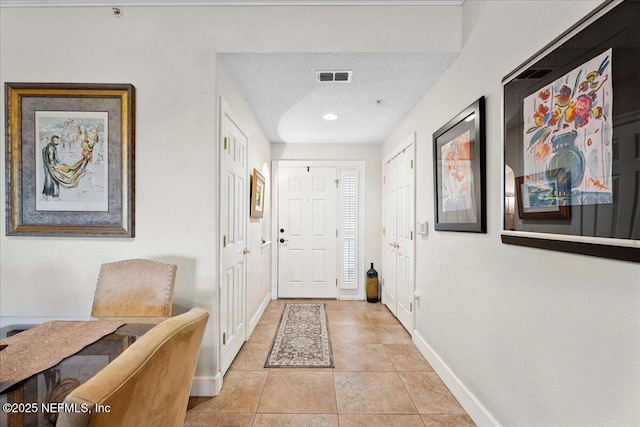 201 S Ocean Grande Dr Unit 104, Ponte Vedra Beach, FL 32082 - entryway with a textured ceiling, light tile patterned flooring, and recessed lighting
