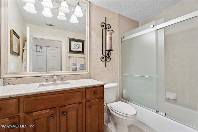 201 S Ocean Grande Dr Unit 104, Ponte Vedra Beach, FL 32082 - full bath featuring vanity, a textured ceiling, and shower / bath combination with glass door