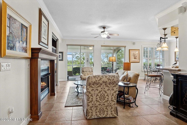 201 S Ocean Grande Dr Unit 104, Ponte Vedra Beach, FL 32082 - living area featuring a tiled fireplace, crown molding, plenty of natural light, ceiling fan, and light tile patterned floors