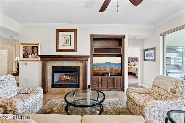 201 S Ocean Grande Dr Unit 104, Ponte Vedra Beach, FL 32082 - living area featuring a ceiling fan, ornamental molding, a fireplace, and a textured ceiling