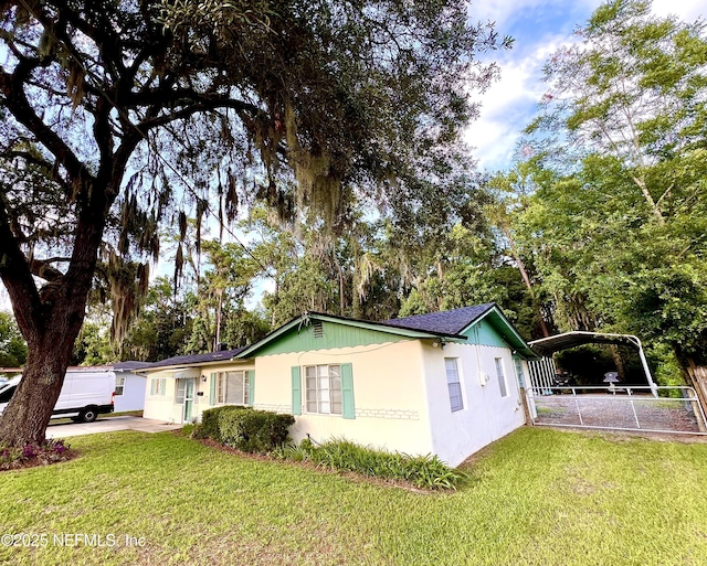 457 Nightingale Rd, Jacksonville, FL 32216 - view of front facade featuring a detached carport and stucco siding