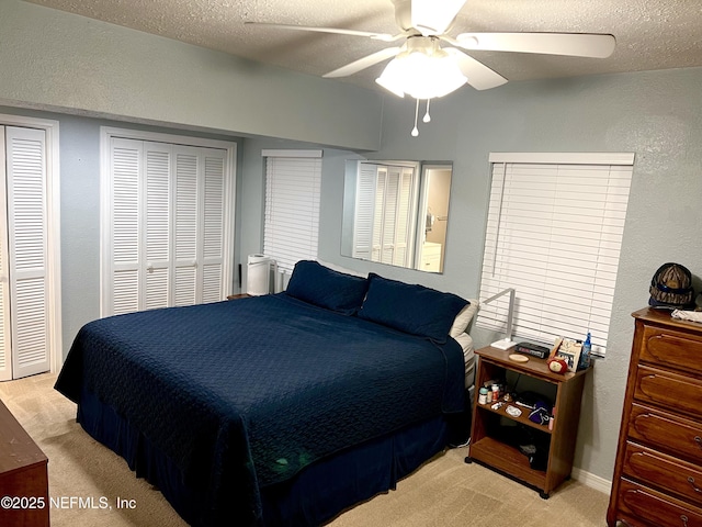 457 Nightingale Rd, Jacksonville, FL 32216 - bedroom featuring light carpet, a textured wall, a textured ceiling, a ceiling fan, and multiple closets