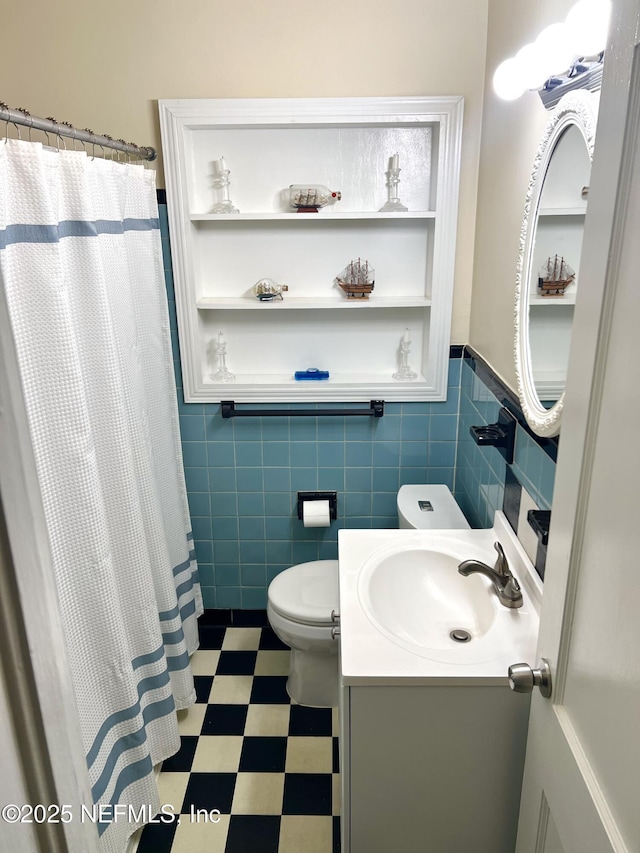 457 Nightingale Rd, Jacksonville, FL 32216 - full bathroom featuring tile walls, vanity, a wainscoted wall, tile patterned floors, and a shower with curtain