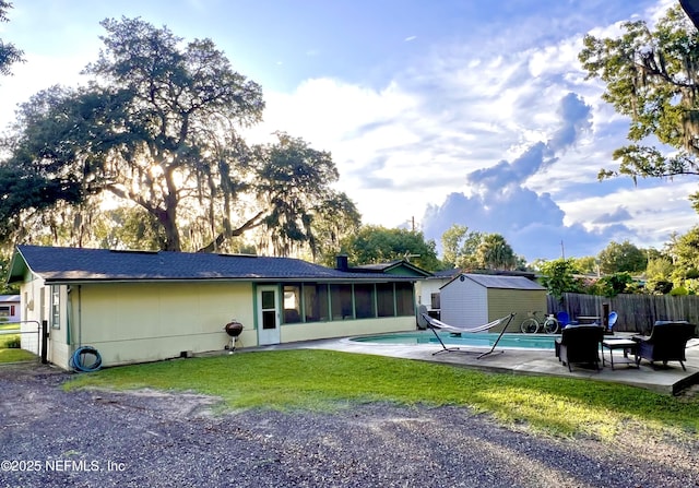 457 Nightingale Rd, Jacksonville, FL 32216 - rear view of property with a sunroom, a patio, and a storage shed