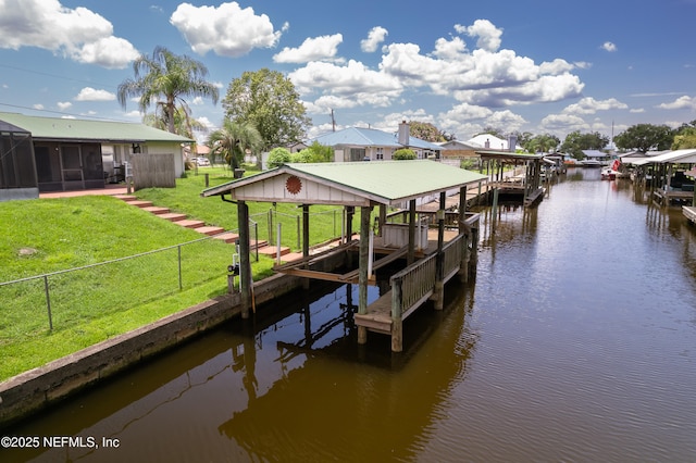 118 Magnolia Dr, East Palatka, FL 32131 - dock with boat lift, a water view, a fenced backyard, and a residential view