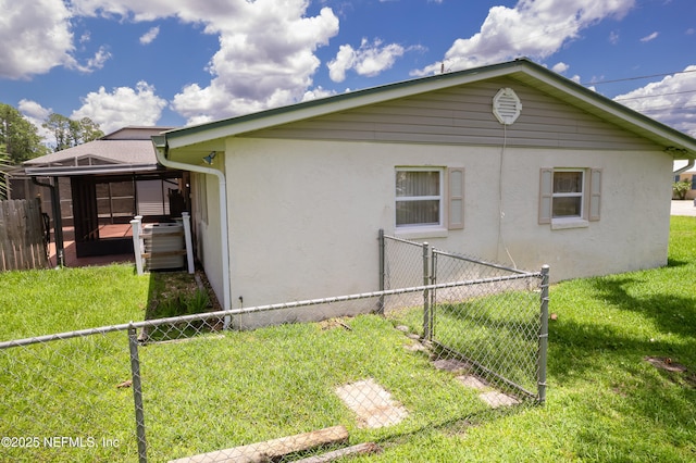 118 Magnolia Dr, East Palatka, FL 32131 - view of property exterior with a fenced backyard, stucco siding, and a gate