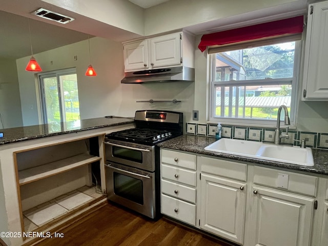 118 Magnolia Dr, East Palatka, FL 32131 - kitchen featuring double oven range, under cabinet range hood, white cabinets, and dark wood-type flooring
