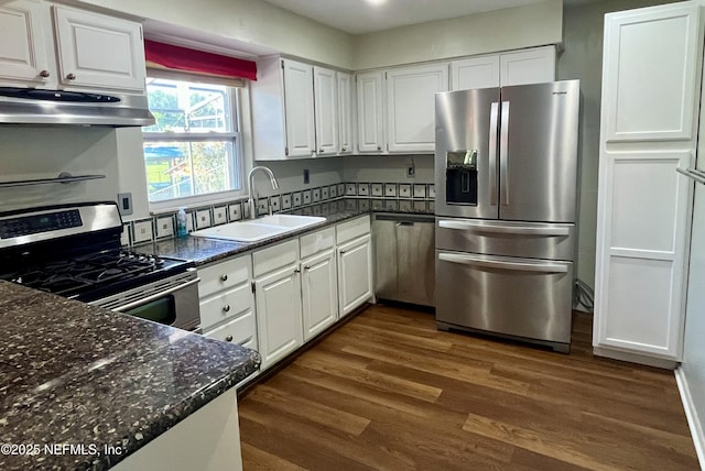 118 Magnolia Dr, East Palatka, FL 32131 - kitchen with appliances with stainless steel finishes, under cabinet range hood, dark wood-style flooring, and white cabinets