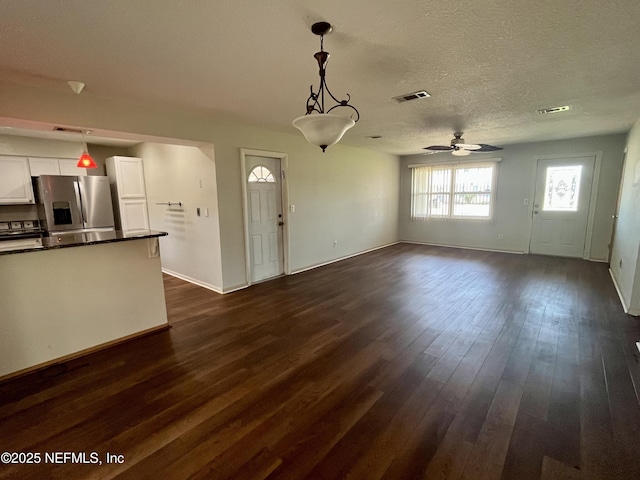 118 Magnolia Dr, East Palatka, FL 32131 - unfurnished living room featuring a ceiling fan, dark wood-style flooring, and a textured ceiling