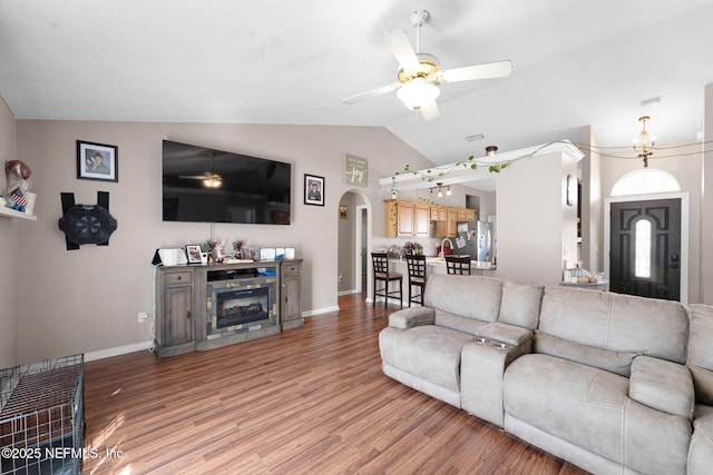2875 Majestic Oaks Ln, Green Cove Springs, FL 32043 - living area featuring a ceiling fan, arched walkways, light wood-style floors, and vaulted ceiling