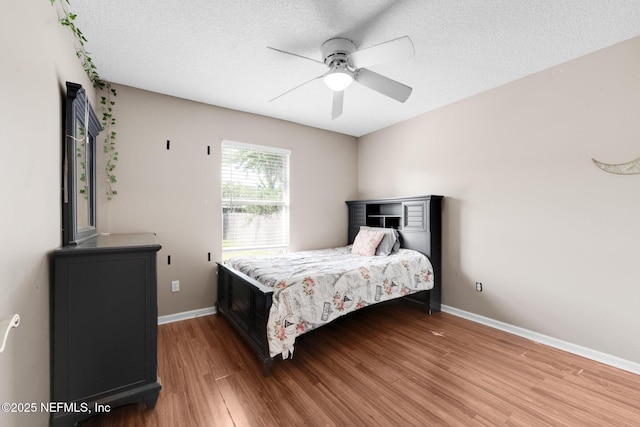 2875 Majestic Oaks Ln, Green Cove Springs, FL 32043 - bedroom featuring wood finished floors, a textured ceiling, and a ceiling fan