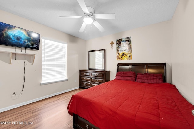 2875 Majestic Oaks Ln, Green Cove Springs, FL 32043 - bedroom featuring wood finished floors, a textured ceiling, and a ceiling fan