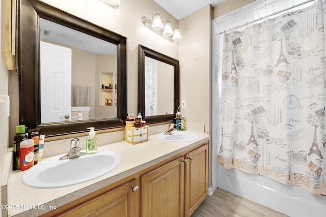 2875 Majestic Oaks Ln, Green Cove Springs, FL 32043 - bathroom with double vanity, shower / tub combo with curtain, and wood finished floors