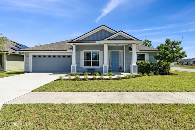 86180 Tranquil Ct, Yulee, FL 32097 - view of front of home featuring a garage, a front yard, concrete driveway, a porch, and board and batten siding
