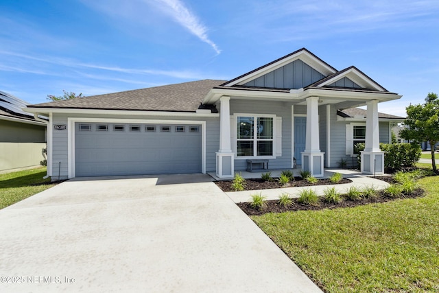 86180 Tranquil Ct, Yulee, FL 32097 - view of front of home featuring an attached garage, driveway, covered porch, board and batten siding, and a front lawn
