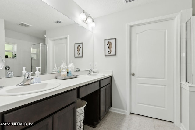 86180 Tranquil Ct, Yulee, FL 32097 - full bath with double vanity, tile patterned floors, a stall shower, and a textured ceiling