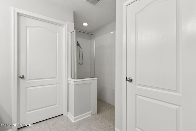 86180 Tranquil Ct, Yulee, FL 32097 - bathroom with walk in shower, tile patterned floors, and a textured ceiling