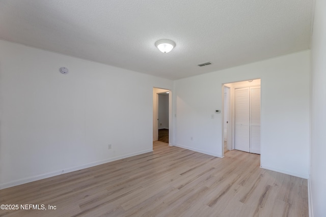 3122 20th St, Jacksonville, FL 32254 - unfurnished room with light wood-type flooring, a textured ceiling, and a smoke detector