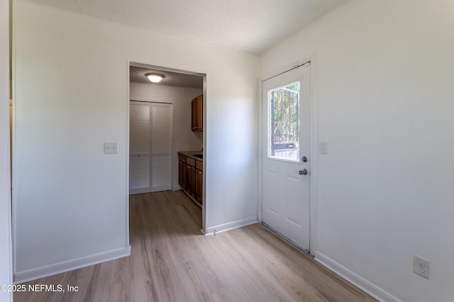 3122 20th St, Jacksonville, FL 32254 - doorway with light wood-style floors and a textured ceiling