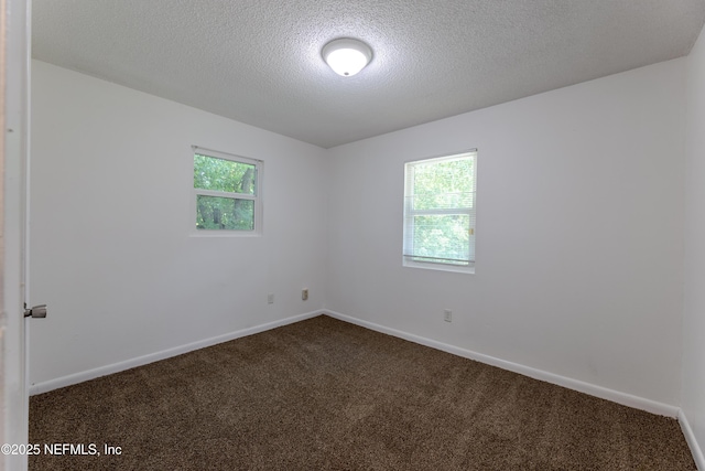 3122 20th St, Jacksonville, FL 32254 - unfurnished room with dark carpet, healthy amount of natural light, and a textured ceiling
