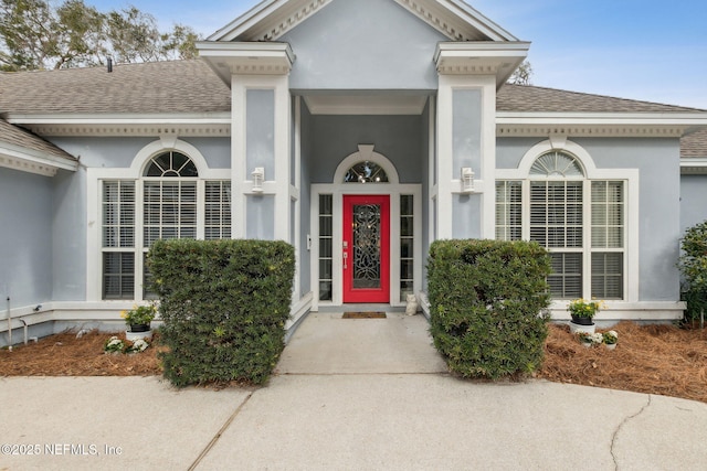 2205 Ashley Ct, Fernandina Beach, FL 32034 - view of exterior entry with roof with shingles and stucco siding