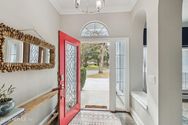 2205 Ashley Ct, Fernandina Beach, FL 32034 - foyer featuring ornamental molding, arched walkways, a chandelier, and wood finished floors