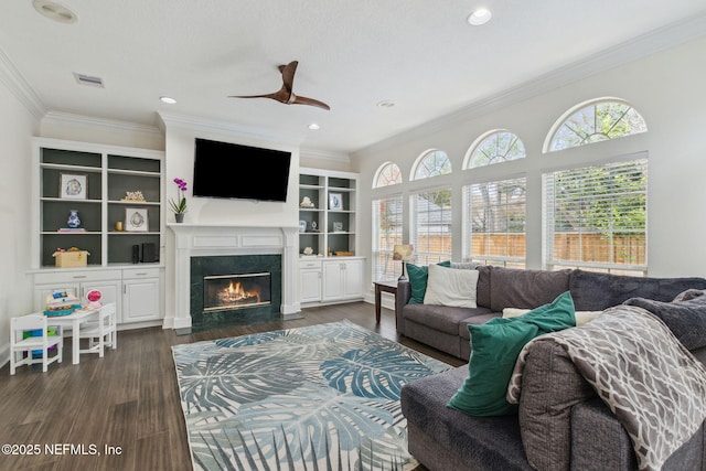 2205 Ashley Ct, Fernandina Beach, FL 32034 - living room with a fireplace with flush hearth, crown molding, a ceiling fan, dark wood-type flooring, and recessed lighting