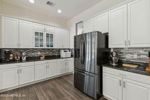 2205 Ashley Ct, Fernandina Beach, FL 32034 - kitchen featuring stainless steel refrigerator with ice dispenser, backsplash, white cabinetry, glass insert cabinets, and recessed lighting