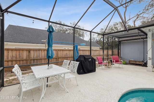 2205 Ashley Ct, Fernandina Beach, FL 32034 - fenced backyard with a patio area, area for grilling, glass enclosure, and outdoor dining space