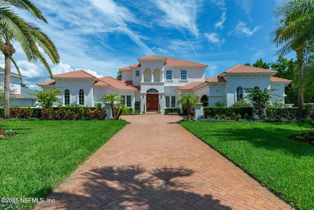 23 Corona Rd, Ponte Vedra Beach, FL 32082 - mediterranean / spanish house with decorative driveway, a front lawn, stucco siding, and a tile roof