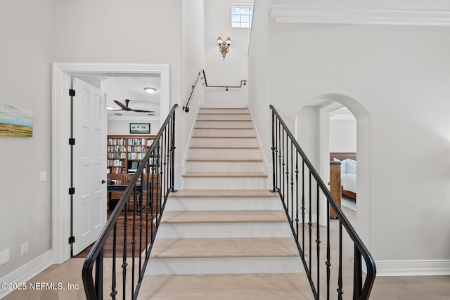 23 Corona Rd, Ponte Vedra Beach, FL 32082 - staircase with wood finished floors, arched walkways, and ceiling fan