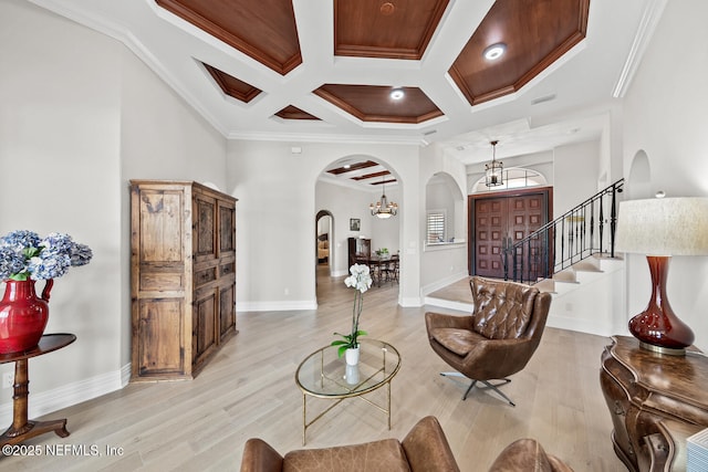 23 Corona Rd, Ponte Vedra Beach, FL 32082 - living room featuring arched walkways, crown molding, coffered ceiling, light wood-type flooring, and stairs