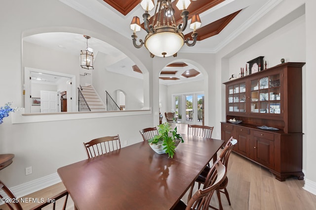 23 Corona Rd, Ponte Vedra Beach, FL 32082 - dining room featuring crown molding, arched walkways, a chandelier, coffered ceiling, and light wood-style floors