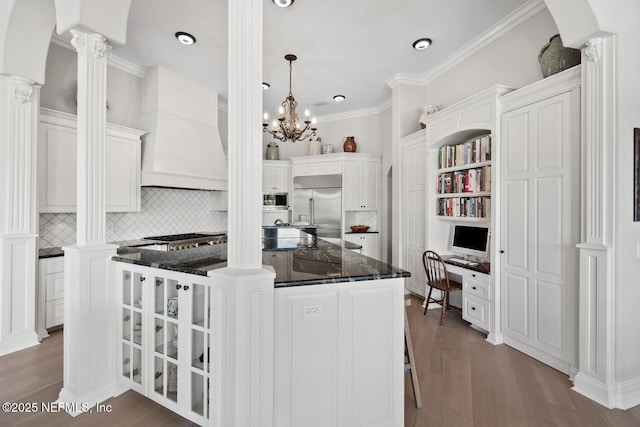 23 Corona Rd, Ponte Vedra Beach, FL 32082 - kitchen featuring built in appliances, decorative backsplash, white cabinetry, dark wood-type flooring, and ornamental molding