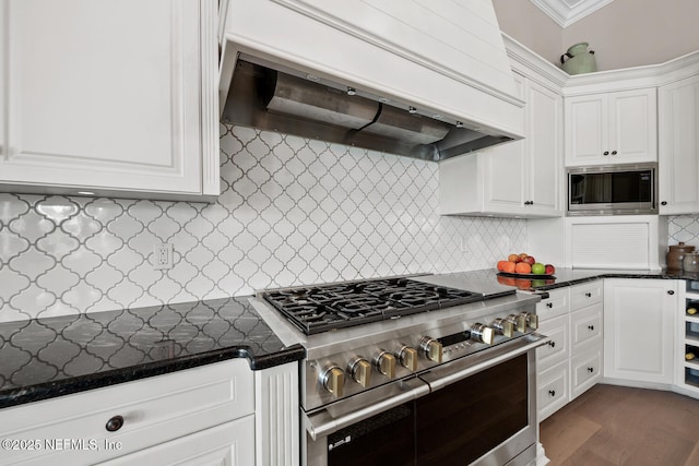 23 Corona Rd, Ponte Vedra Beach, FL 32082 - kitchen featuring stainless steel appliances, extractor fan, white cabinetry, backsplash, and dark wood-style floors