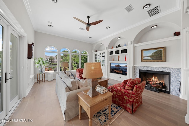 23 Corona Rd, Ponte Vedra Beach, FL 32082 - living room with a tiled fireplace, light wood finished floors, ceiling fan, ornamental molding, and recessed lighting