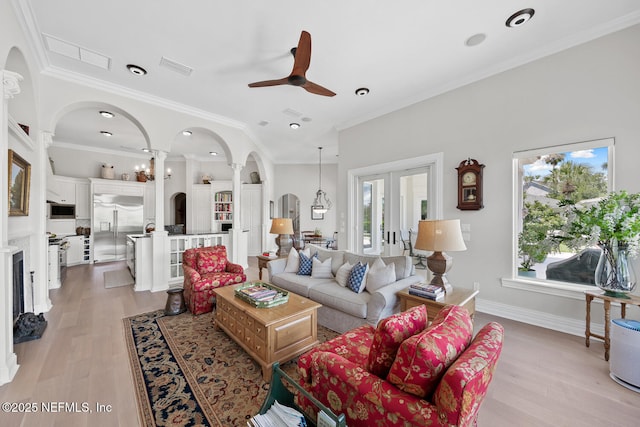 23 Corona Rd, Ponte Vedra Beach, FL 32082 - living room with ceiling fan, arched walkways, light wood finished floors, crown molding, and french doors
