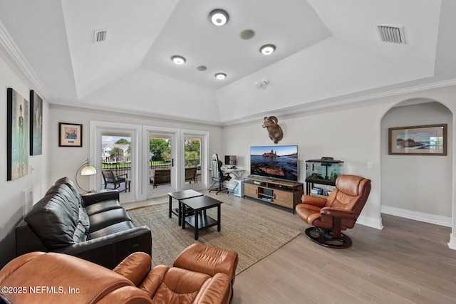 23 Corona Rd, Ponte Vedra Beach, FL 32082 - living room featuring a tray ceiling, arched walkways, wood finished floors, and ornamental molding
