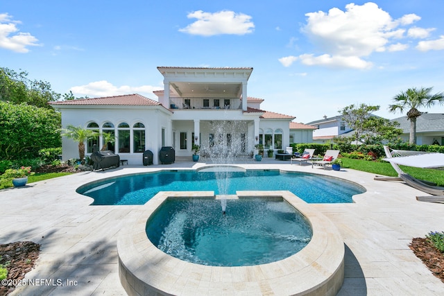 23 Corona Rd, Ponte Vedra Beach, FL 32082 - rear view of property featuring a balcony, a tiled roof, a patio, a pool with connected hot tub, and stucco siding