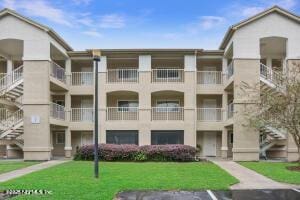 7 Arbor Club Dr Unit 214, Ponte Vedra Beach, FL 32082 - view of apartment building / complex featuring uncovered parking