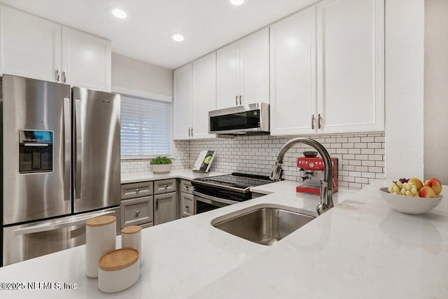 7 Arbor Club Dr Unit 214, Ponte Vedra Beach, FL 32082 - kitchen with stainless steel appliances, decorative backsplash, white cabinets, and recessed lighting
