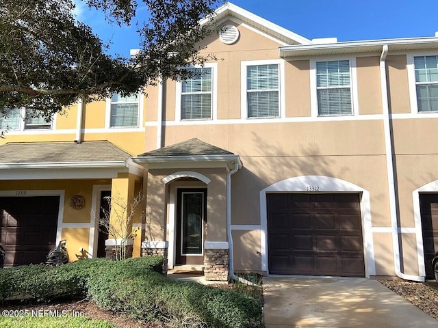 13312 Low Tide Way, Jacksonville, FL 32258 - view of property with an attached garage, stucco siding, and driveway